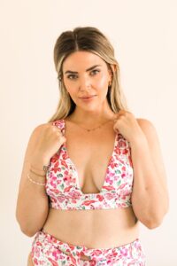 Model wearing florals hidden as vulva pattern bikini top. 