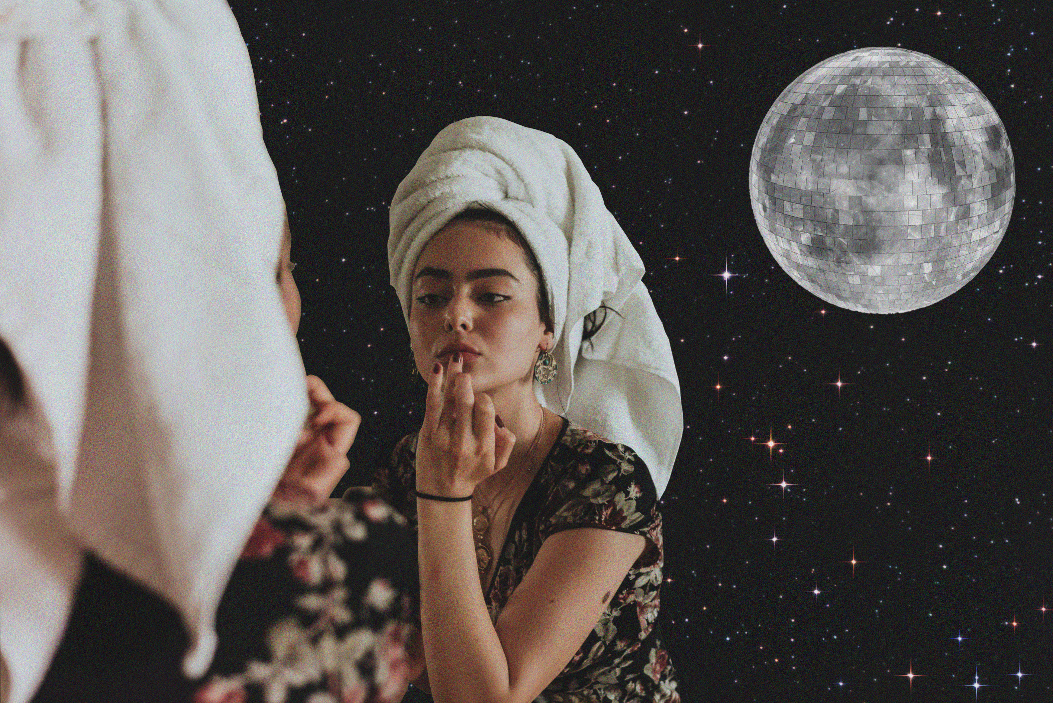 Woman staring in reflection with disco moon behind her