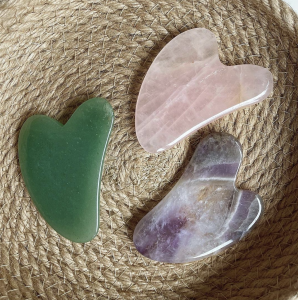 Jade, Rose Quartz and Amethyst Gua Sha Tools in a woven basket